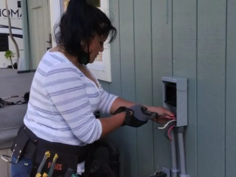Licensed electrician wiring an exterior subpanel in Coldwater